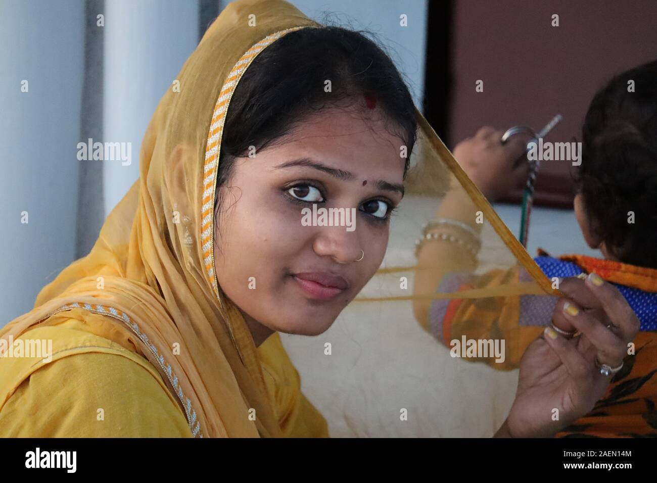 Portrait of young beautiful cute cheerful girl smiling looking at camera over color background.Portrait of a traditionally dressed woman of Indian ori Stock Photo