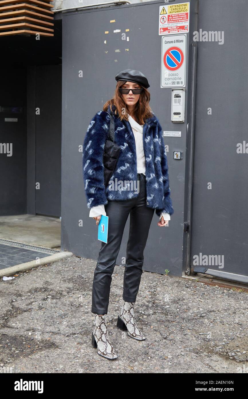 MILAN, ITALY - SEPTEMBER 22, 2019: Woman with blue fur jacket with white Fila logos before Fila fashion show, Milan Fashion Week street style Stock Photo
