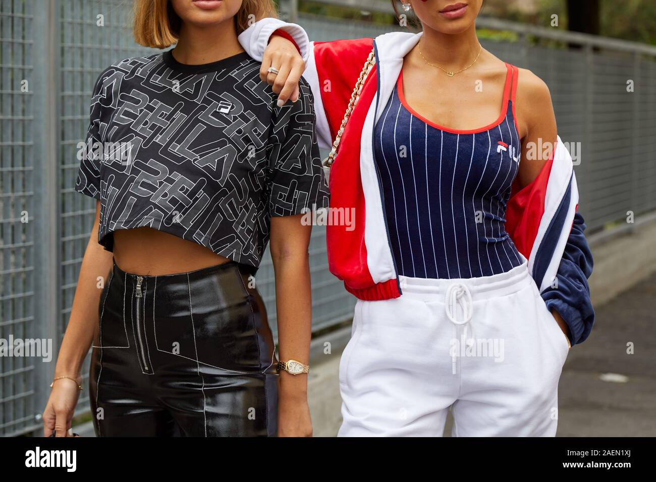 MILAN, ITALY - SEPTEMBER 22, 2019: Women with black shirt and blue and white striped shirt before Fila fashion show, Milan Fashion Week street style Stock Photo