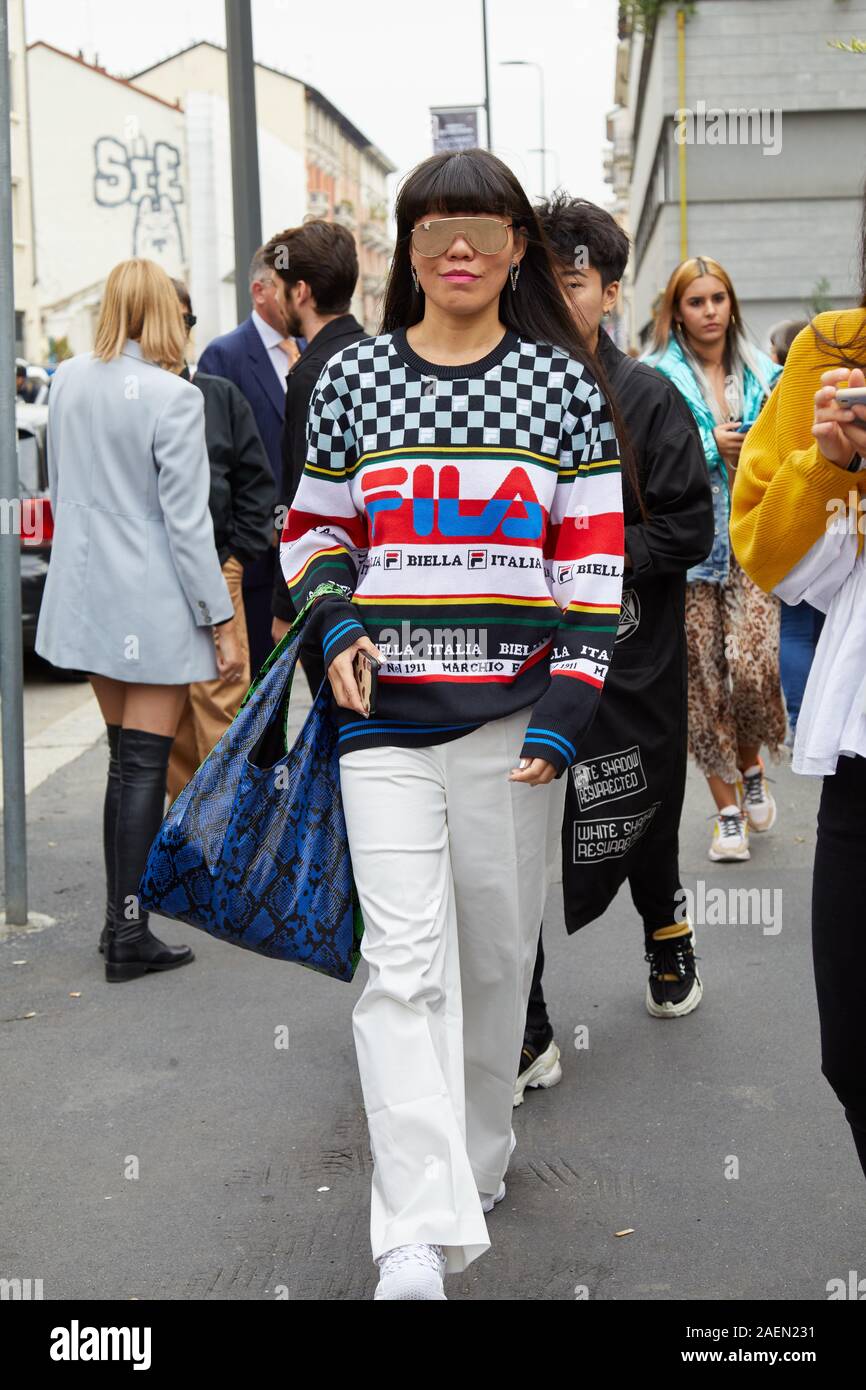 MILAN, ITALY - SEPTEMBER 22, 2019: Woman with Fila sweater and white  trousers before Fila fashion show, Milan Fashion Week street style Stock  Photo - Alamy