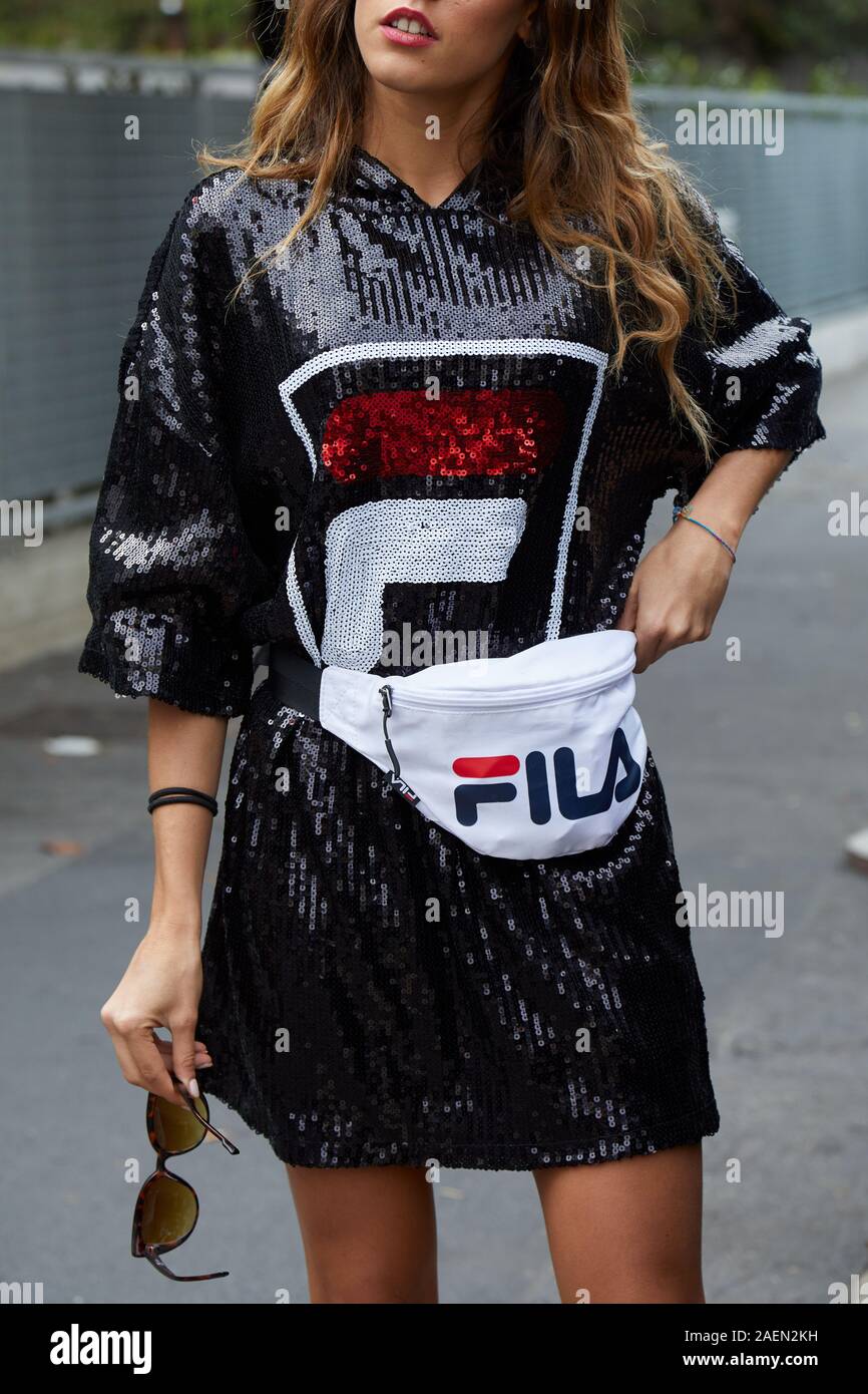 MILAN, ITALY - SEPTEMBER 22, 2019: Woman with black sequin Fila dress and  white pouch before Fila fashion show, Milan Fashion Week street style Stock  Photo - Alamy