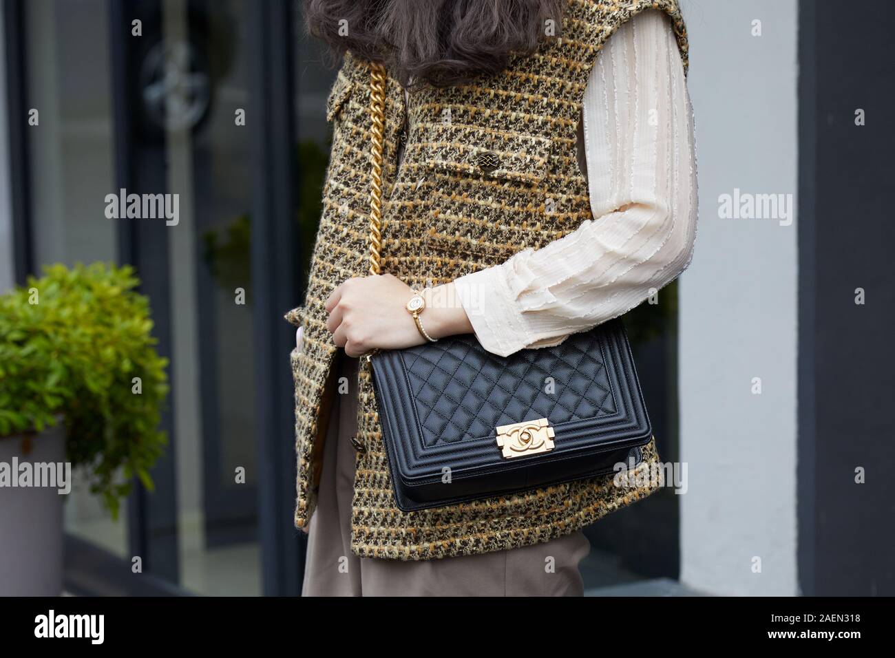 MILAN, ITALY - SEPTEMBER 22, 2019: Woman with black Chanel leather