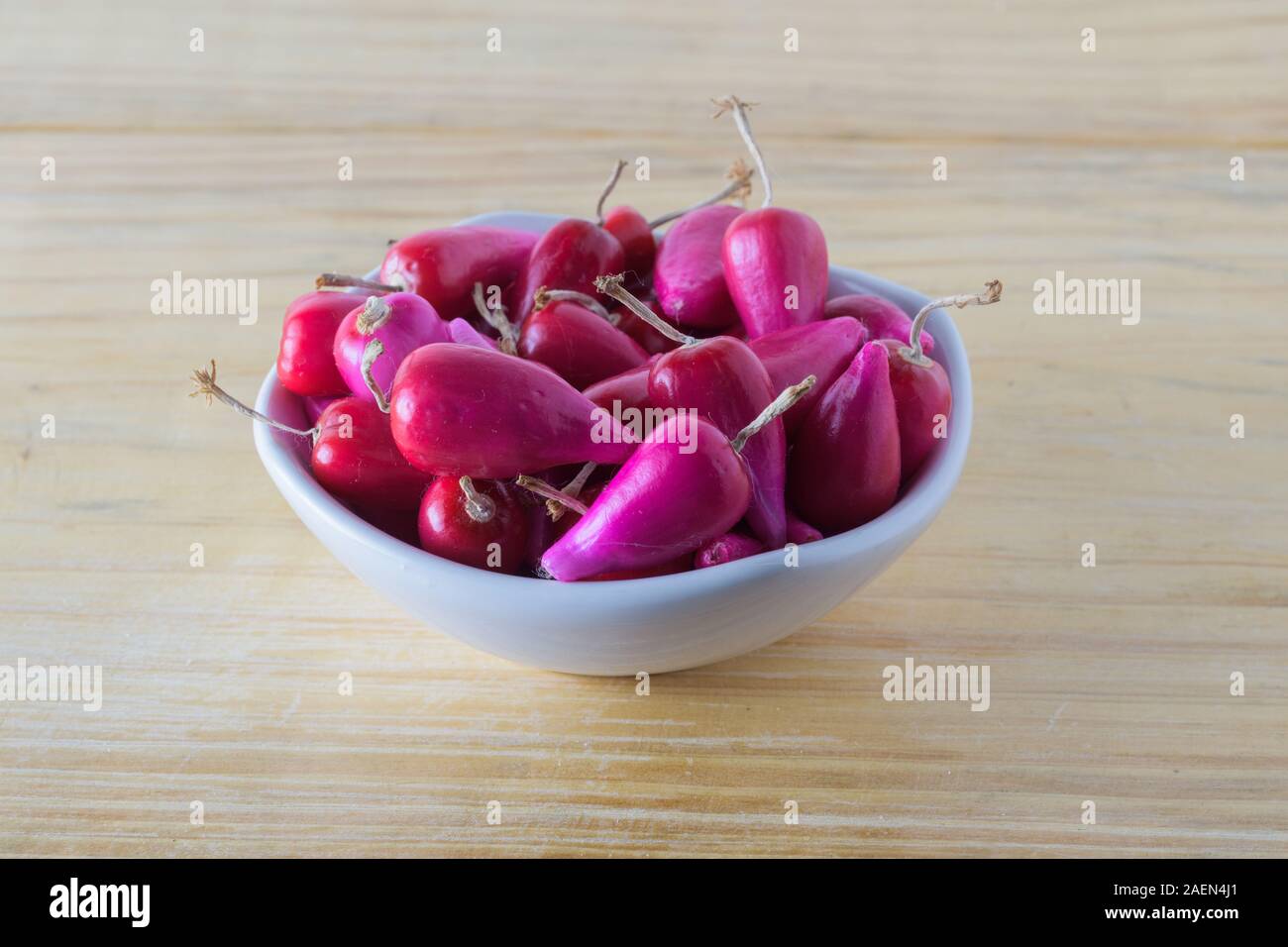 Fresh Pitiguey fruit group in white bowl on wood table Stock Photo