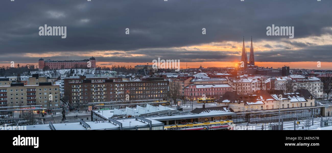 View over central Uppsala at the railway station in the winter at sunset. Uppsala, Sweden, Scandinavia. Stock Photo