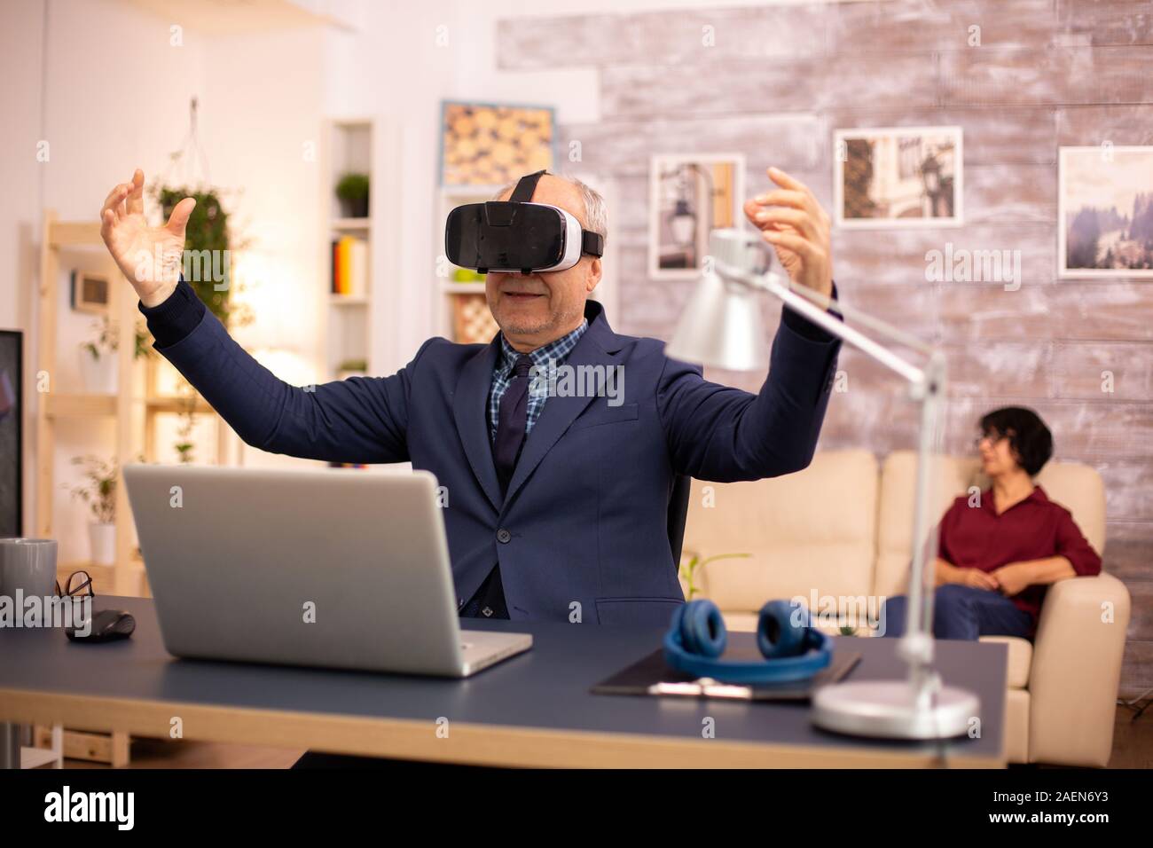 Elderly man experiencing new virtual reality technology for the first time in his home Stock Photo