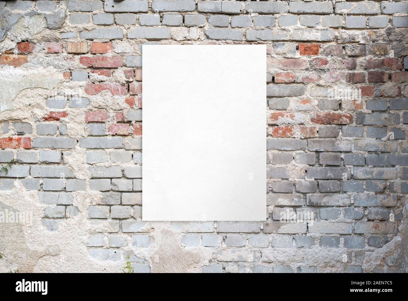 Poster mockup on an old brick street building wall. Clean, isolated paper for advertising presentation Stock Photo