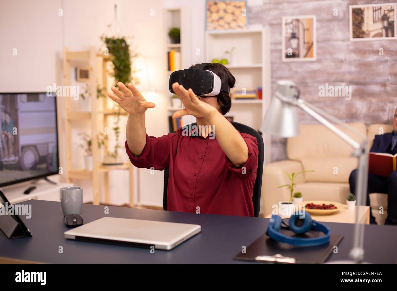 Old elderly woman using a VR virtual reality headset for the first time