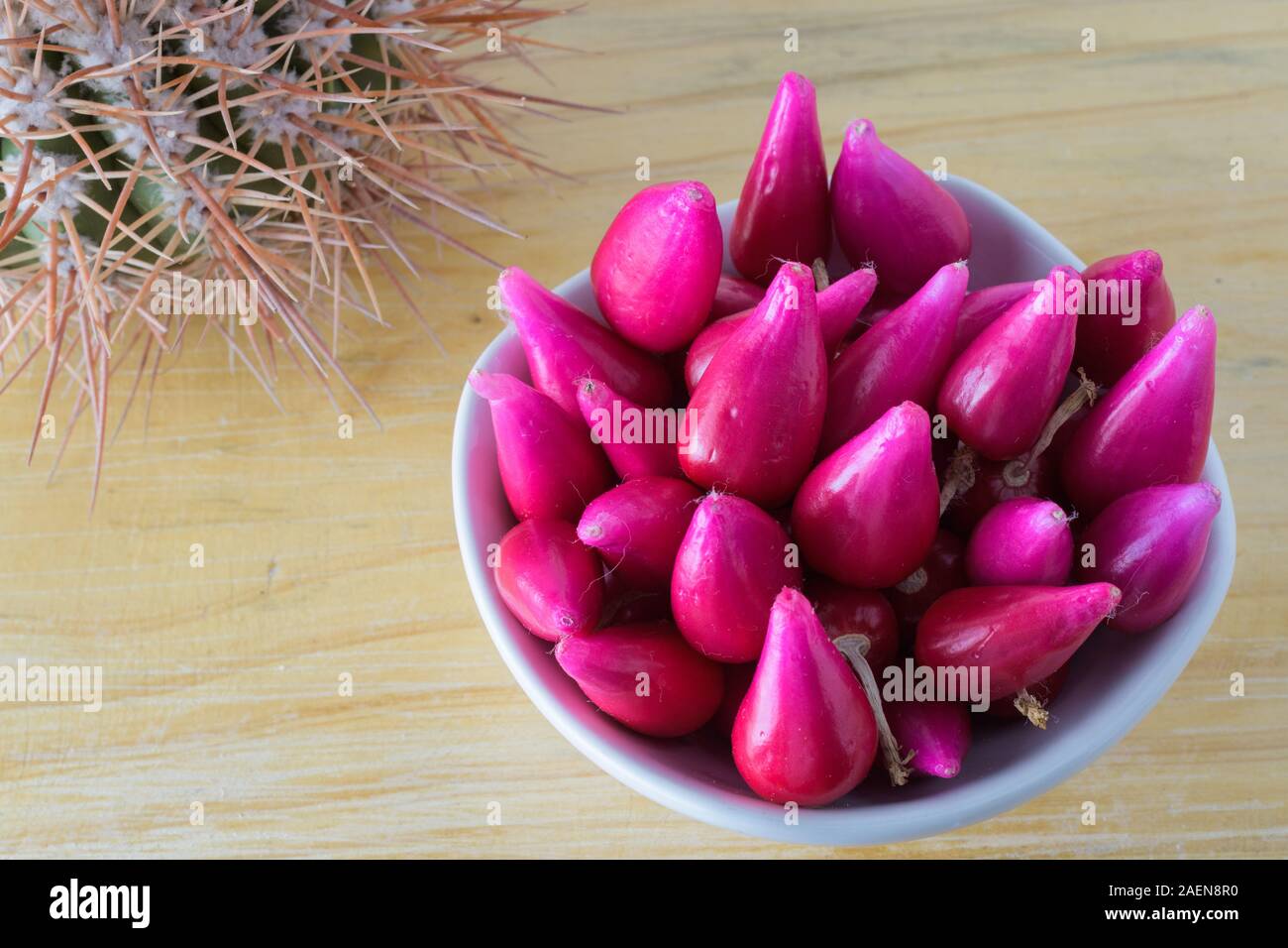 Pitiguey fruit in white bowl on wood table with Cactus Stock Photo