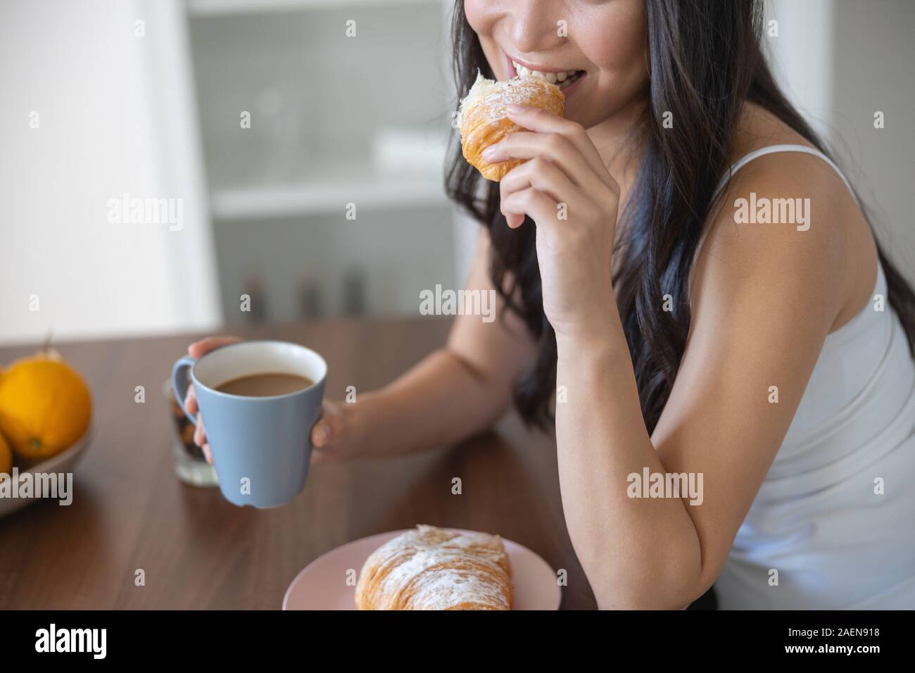 Girl with long hair sitting at the table Stock Photo
