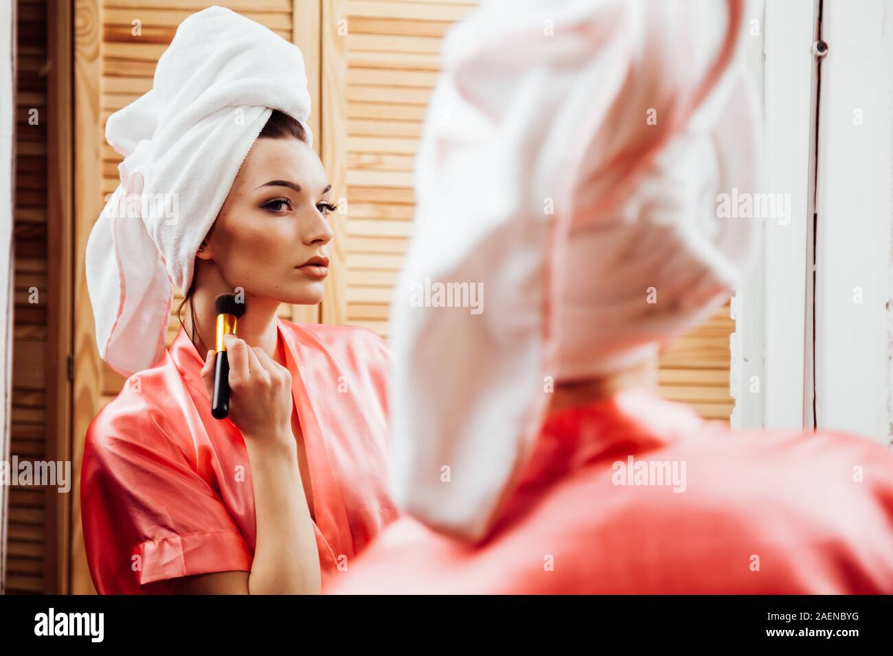 girl after shower makes makeup in the bathroom Stock Photo Alamy
