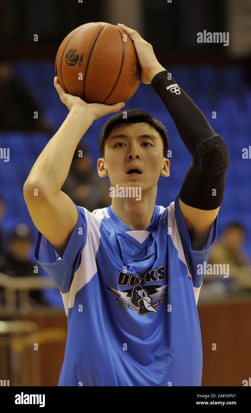 --FILE--Ji Zhe of Beijing Duck shoot during warm-up at a CBA game in Changzhou city, east China's Jiangsu province, 6 February 2013. Former Beijing Ducks' player Ji Zhe, three-time winner of the Chinese Basketball Association league, died of lung cancer early on 5 December 2019. Stock Photo