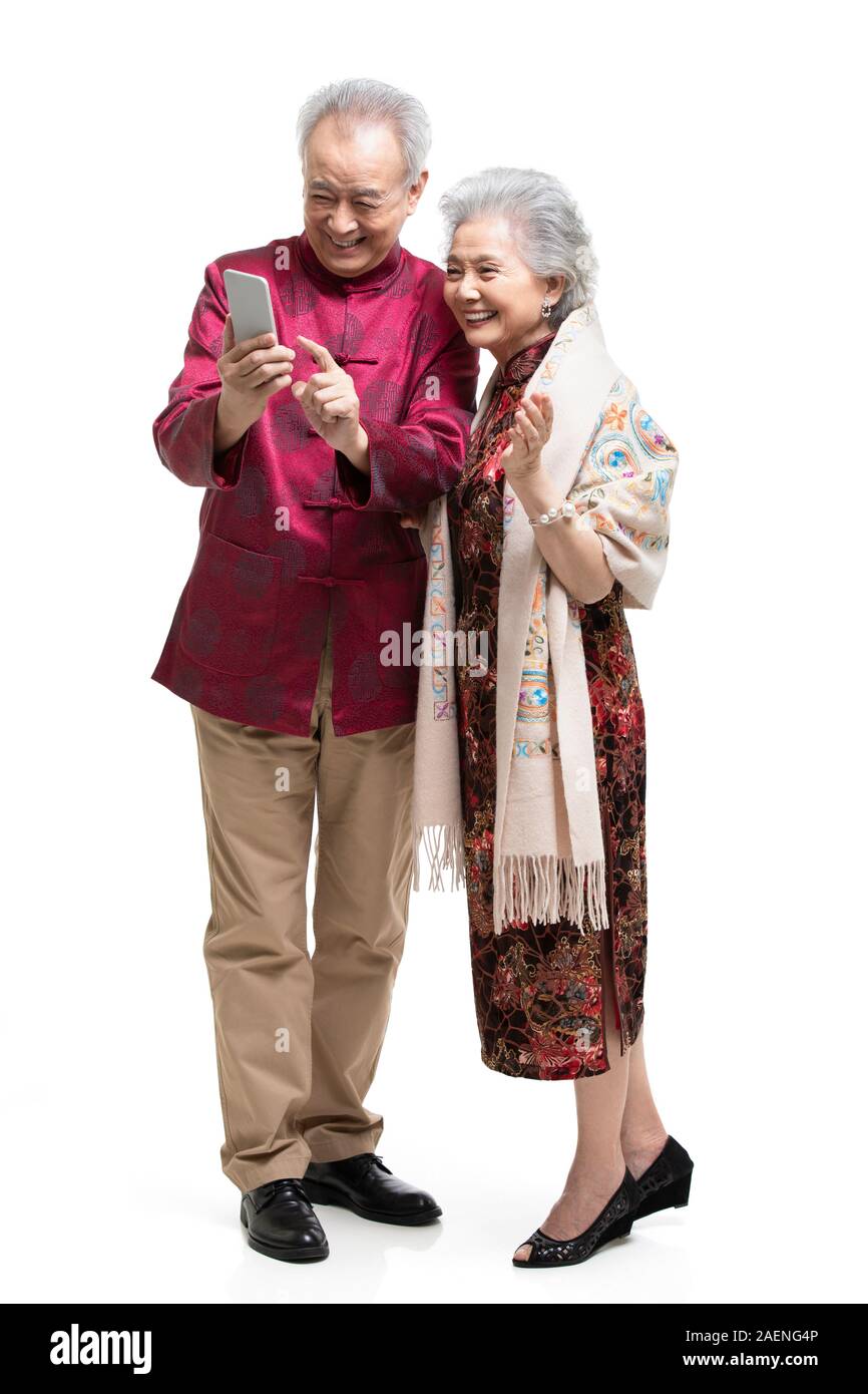 Happy senior couple using smartphone Stock Photo