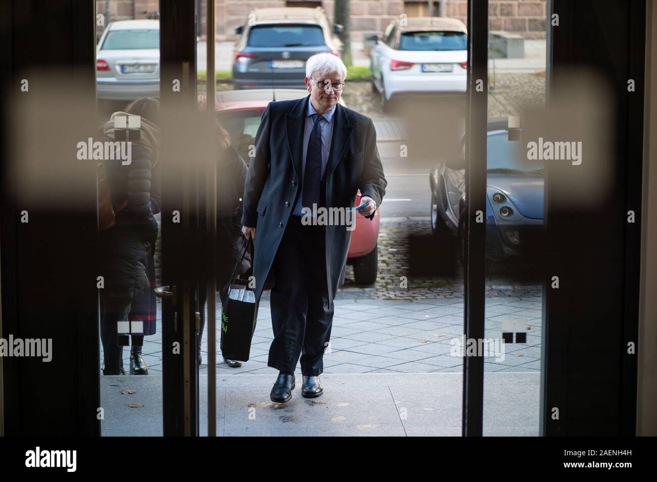 Kassel, Germany. 10th Dec, 2019. Jürgen Resch, Managing Director of Deutsche Umwelthilfe, comes to the Hessian Administrative Court at the beginning of the trial. In an appeal against an action brought by Deutsche Umwelthilfe, the court is dealing with possible bans on diesel driving in the city of Frankfurt am Main. Credit: Swen Pförtner/dpa/Alamy Live News Stock Photo