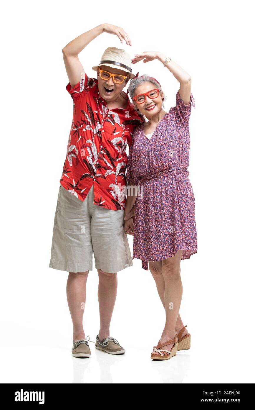 Happy senior couple making heart shape Stock Photo - Alamy