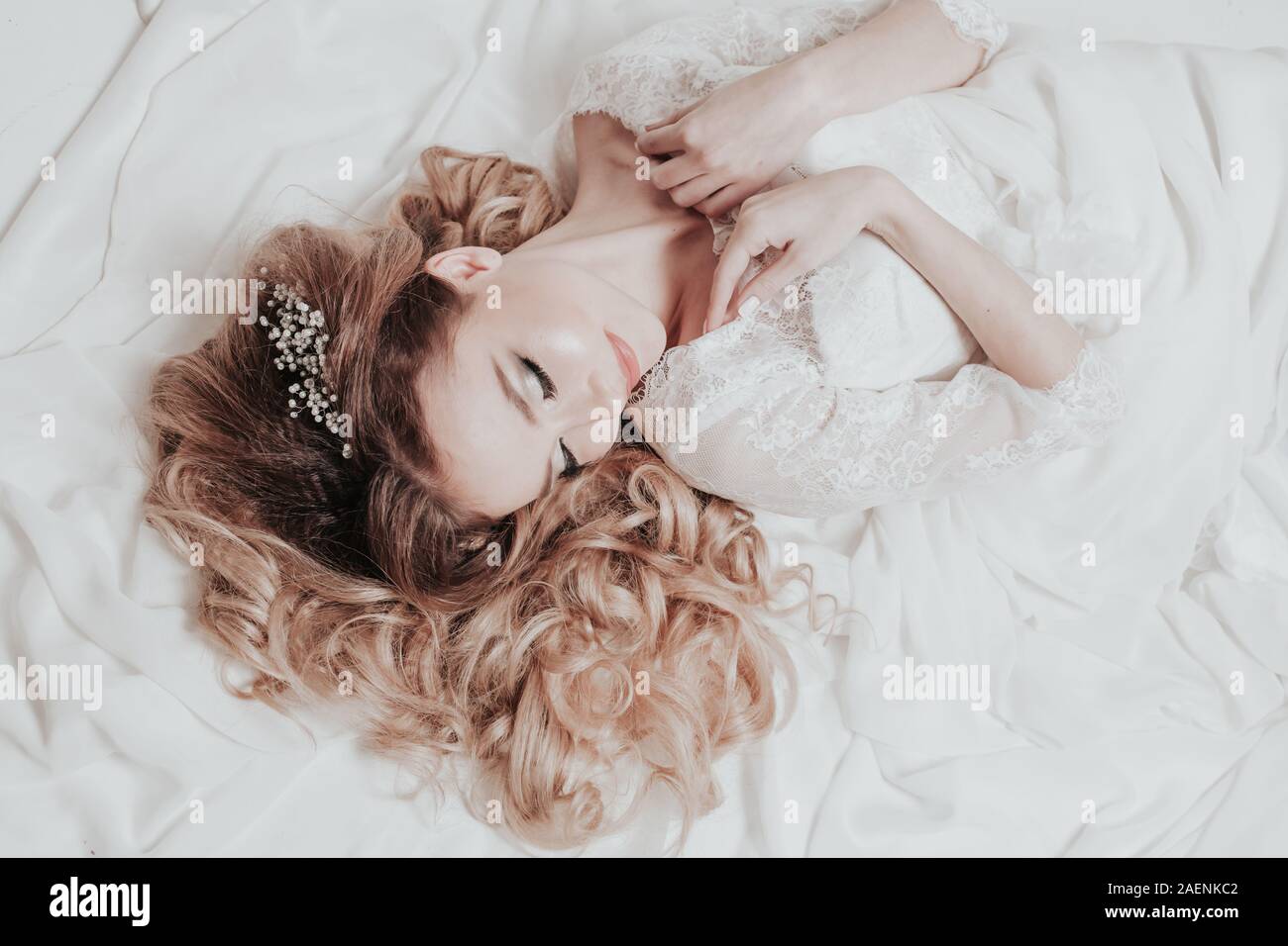 the bride in her wedding dress lay Stock Photo Alamy