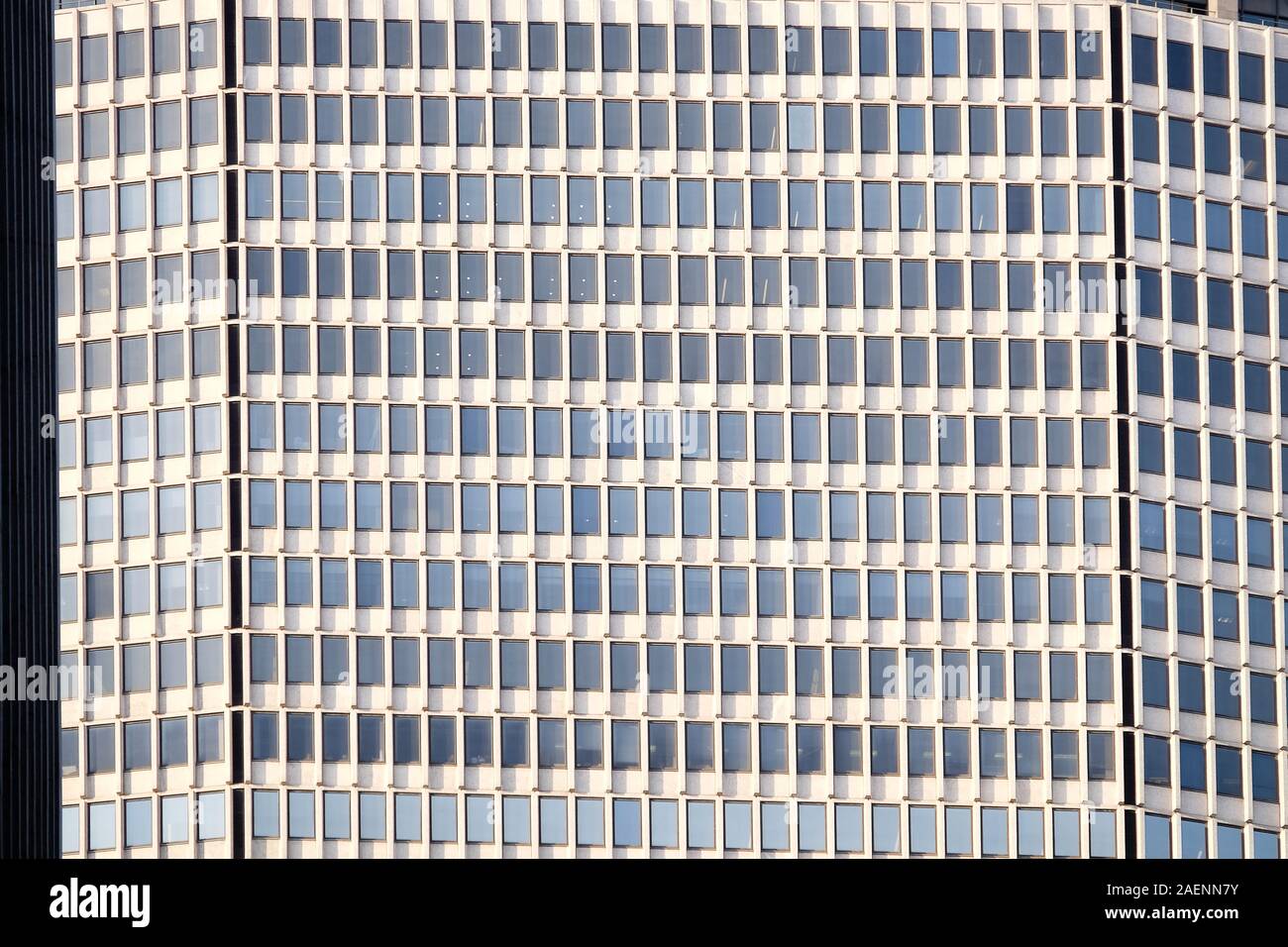 Uniform symmetrical windows of office block building Stock Photo