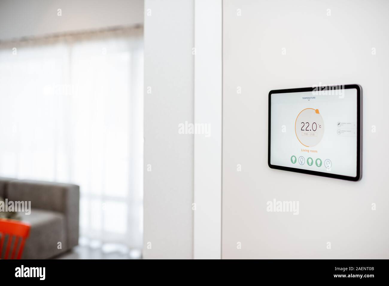Digital touch screen panel for smart home managing with launched heating control application installed on the wall Stock Photo