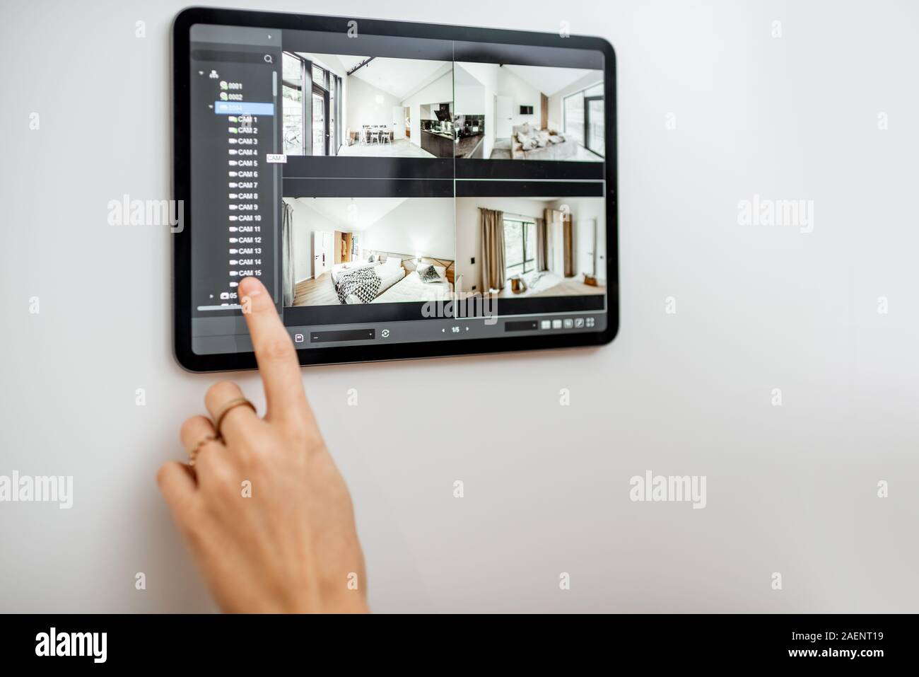 Controlling home with video cameras and digital tablet. Concept of remote video surveillance over the internet with smart touch screen devices Stock Photo