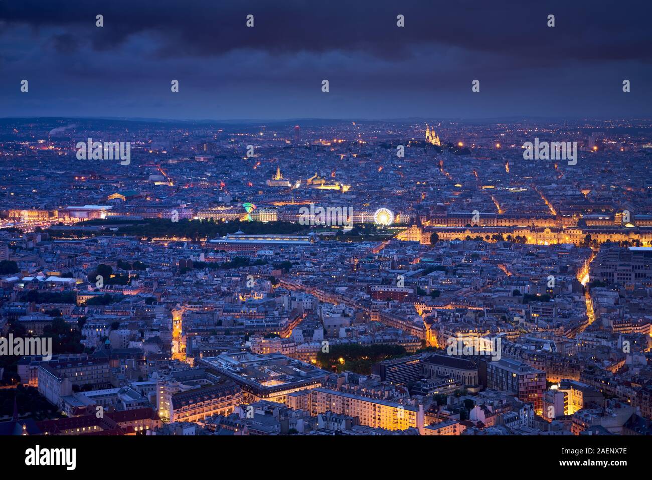 Paris aerial view at twilight with the Jardins des Tuileries, Le Louvre and Montmartre Sacré-Coeur. Rooftops of Paris, 1st, 7th, 18th Arrondissements Stock Photo