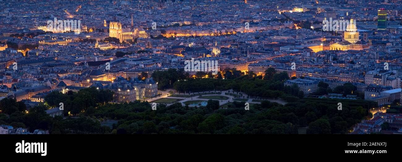 Paris aerial panoramic view at twilight with Luxembourg Gardens, City Hall, illuminated Notre-Dame de Paris Cathedral and the Pantheon. Paris rooftops Stock Photo