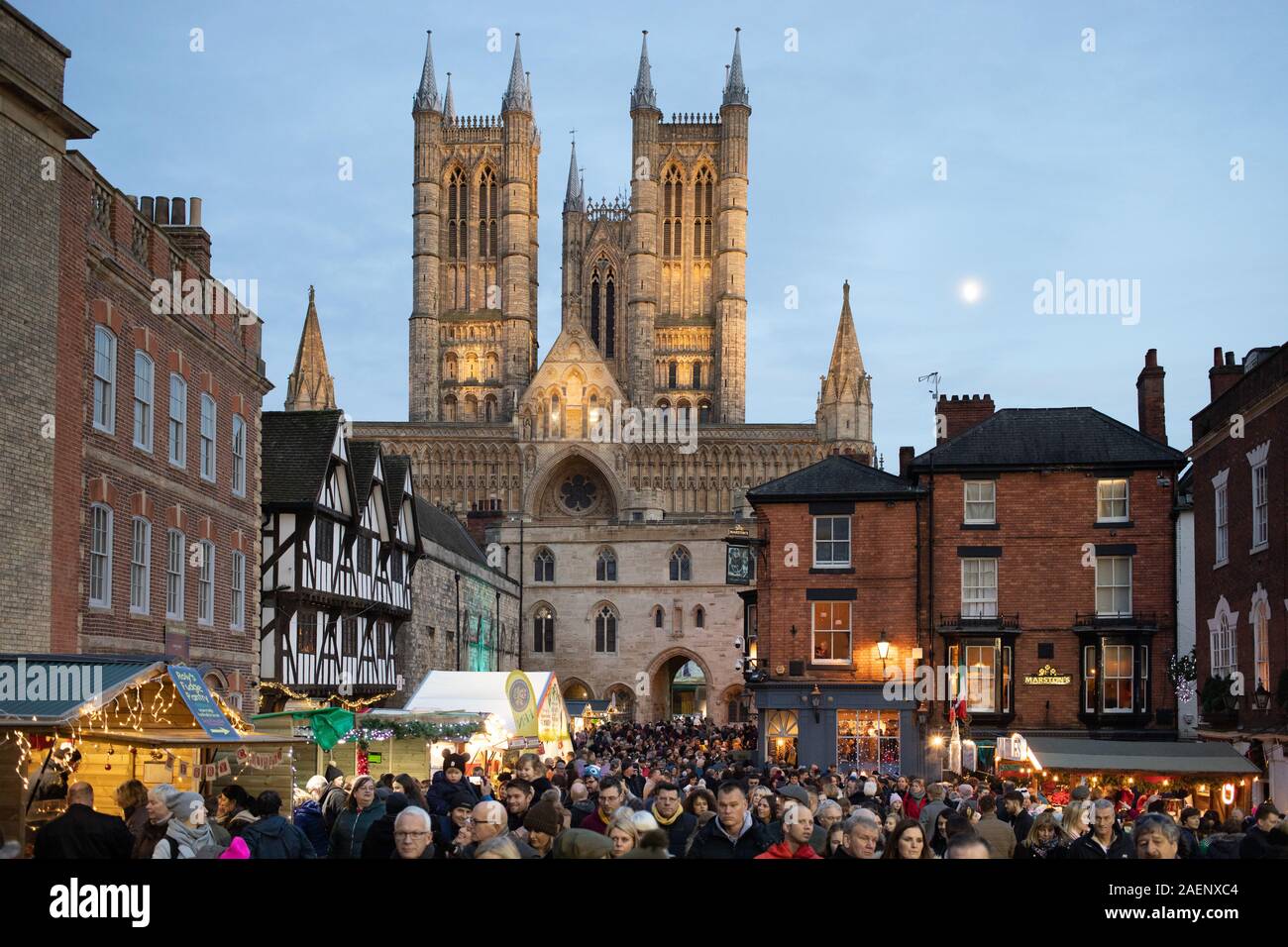 Lincoln Cathedral pictured with new floodlighting installed during 2019. The picture was taken during the annual Christmas market before Christmas. Stock Photo