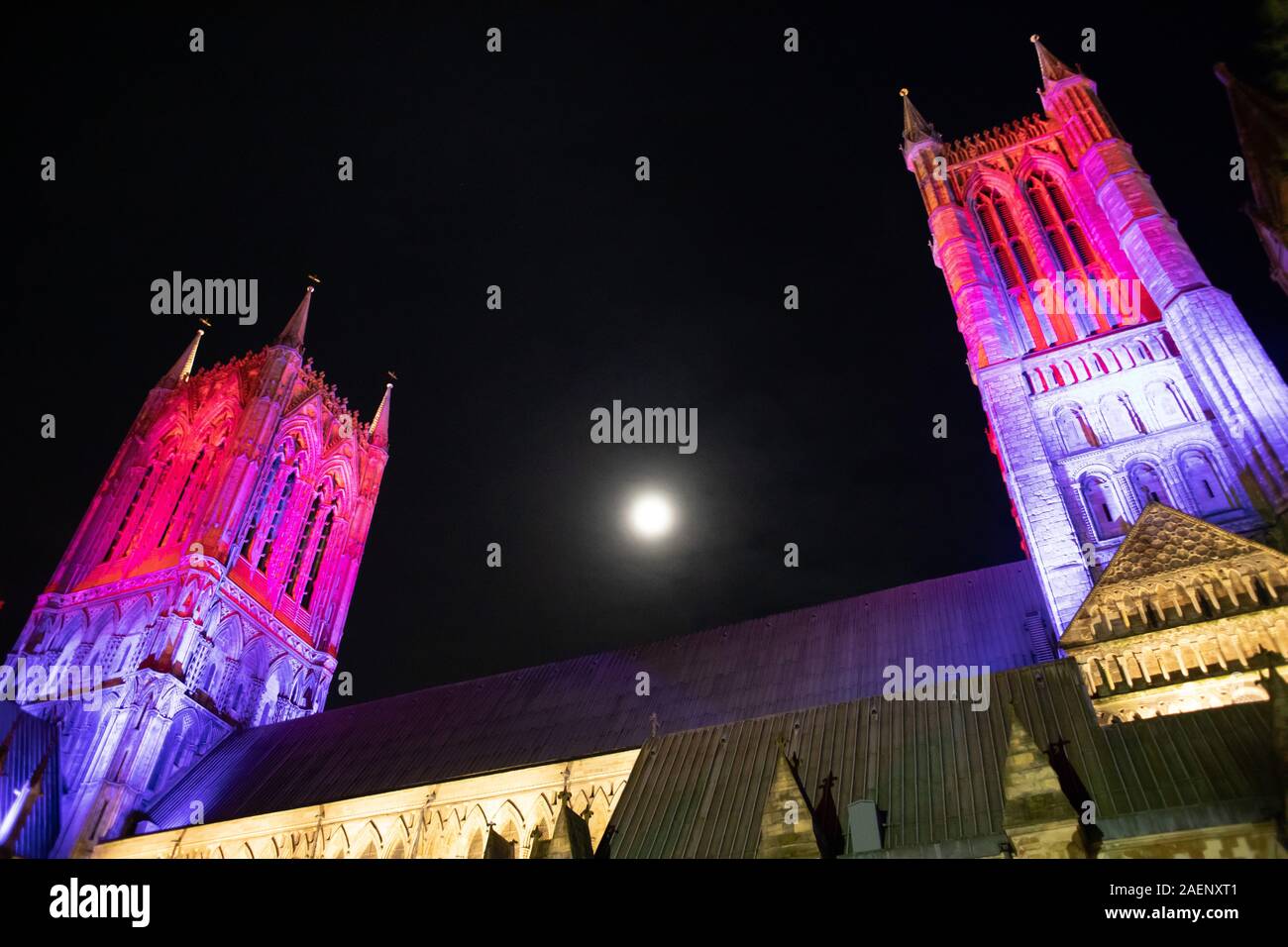 Lincoln Cathedral floodlit using coloured light introduced in 2019. Picture taken from the side of the Cathedral. Stock Photo
