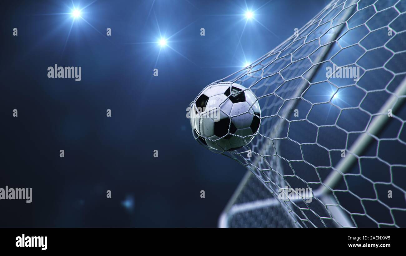 Soccer ball flew into the goal. Soccer ball bends the net, against the background of flashes of light. Soccer ball in goal net on blue background. A Stock Photo