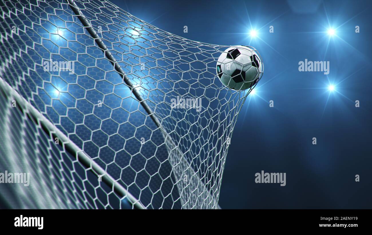 Soccer ball flew into the goal. Soccer ball bends the net, against the background of flashes of light. Soccer ball in goal net on blue background. A Stock Photo