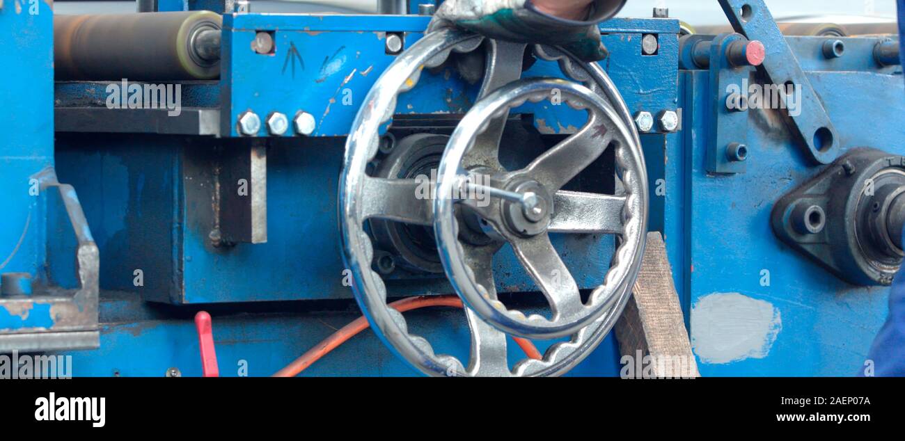 Manual operated handle ball valve with focus on stem and nut of the hand wheel in mechanical workshop, at industrial plant or factory. Equipment, cabl Stock Photo