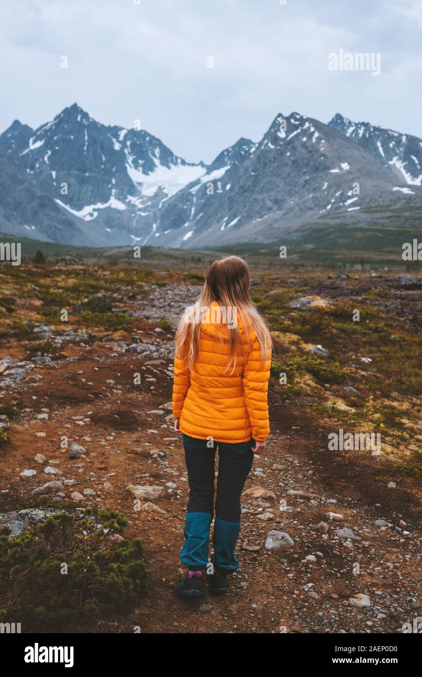 Traveler woman enjoying mountains view outdoor adventure hiking activity vacations alone healthy lifestyle woman exploring Lyngen Alps in Norway Stock Photo
