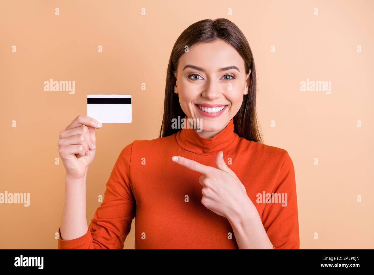 Photo of charming cute cheerful girlfriend showing you that using electronic way of payment is more comfortable holding credit card with her hand Stock Photo