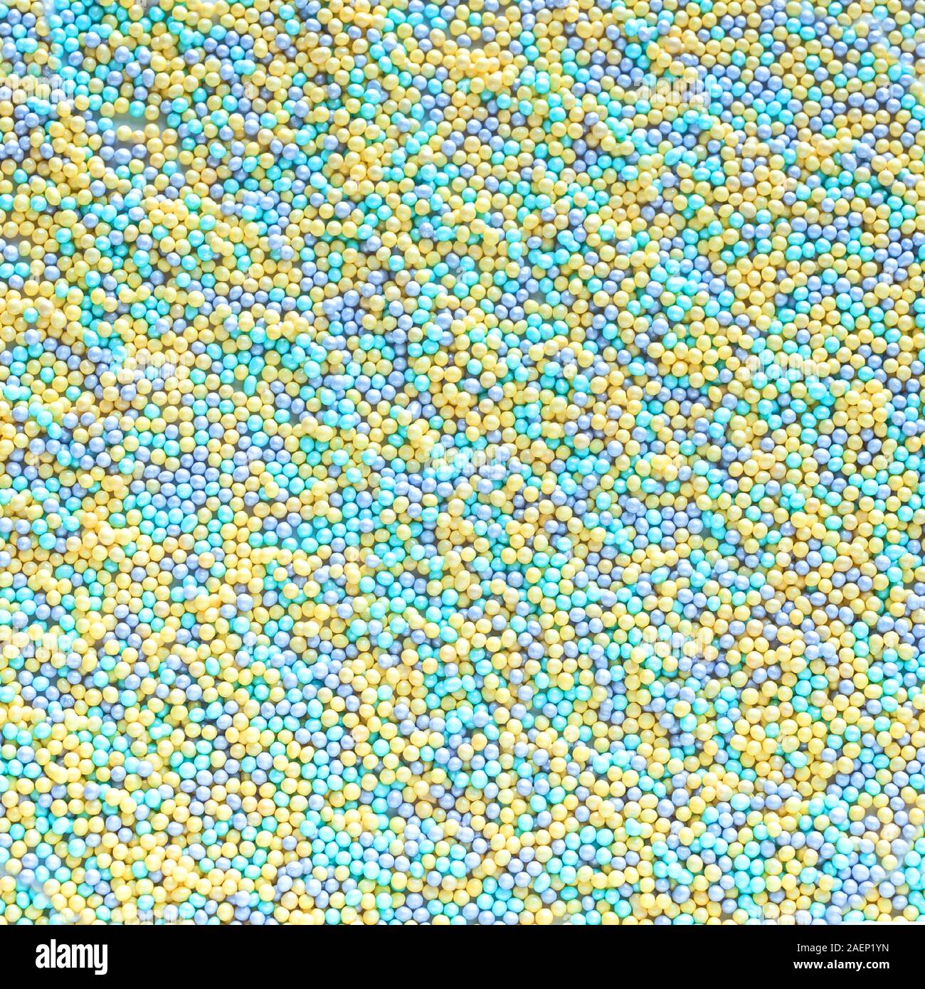 Colorful Pastel Sprinkles as background, top view. Blue and yellow