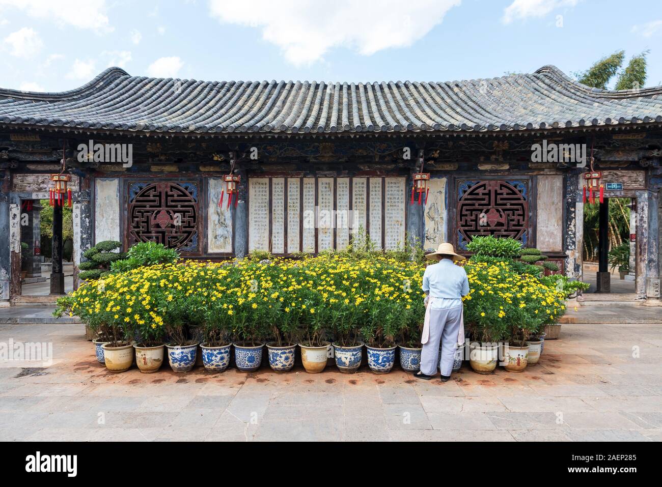 March 7, 2019: Gardener taking care of some plants in a historic building at the city of Jianshui, Yunnan, China Stock Photo