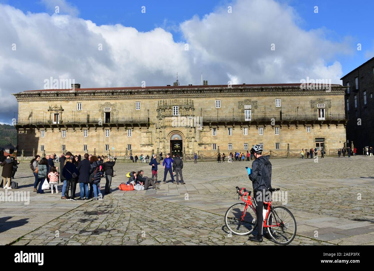 Pilgrims taking pictures in front of Cathedral at Praza do Obradoiro with Hostal de los Reyes Católicos. Santiago de Compostela, Spain. Dec 1, 2019. Stock Photo