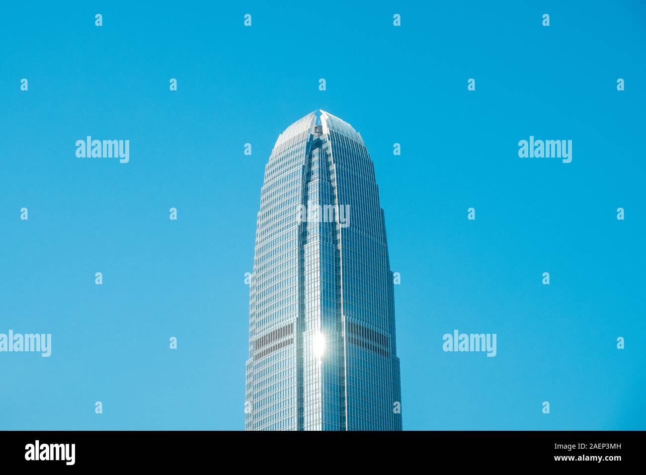 HongKong, China - November, 2019: Top of the two International Finance Centre skyscraper building in Central Hong Kong on clear blue sky Stock Photo