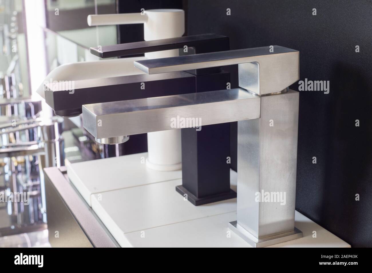 A Variety Of Faucets Taps On A White Shelf In A Shop Counter