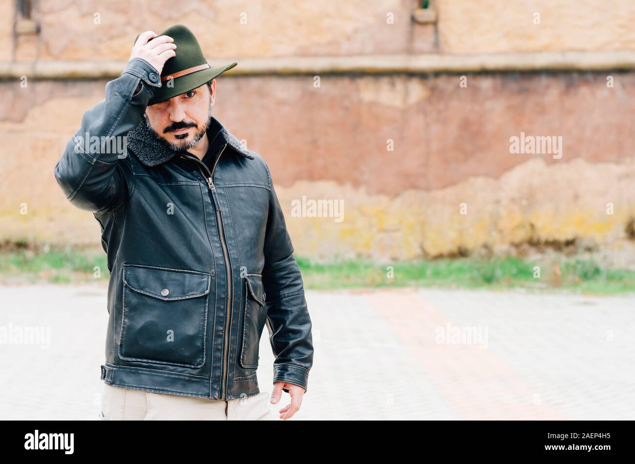 man with jacket and hat in the street Stock Photo