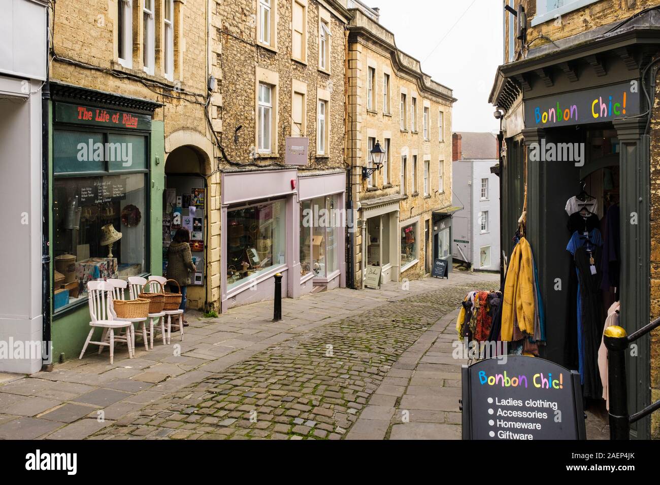 Looking down a narrow cobbled street with independent small shops. Catherine Hill, Frome, Somerset, England, UK, Britain Stock Photo