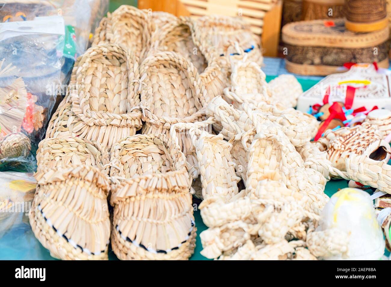 Souvenir bast shoes woven from bast. Old traditional Russian shoes