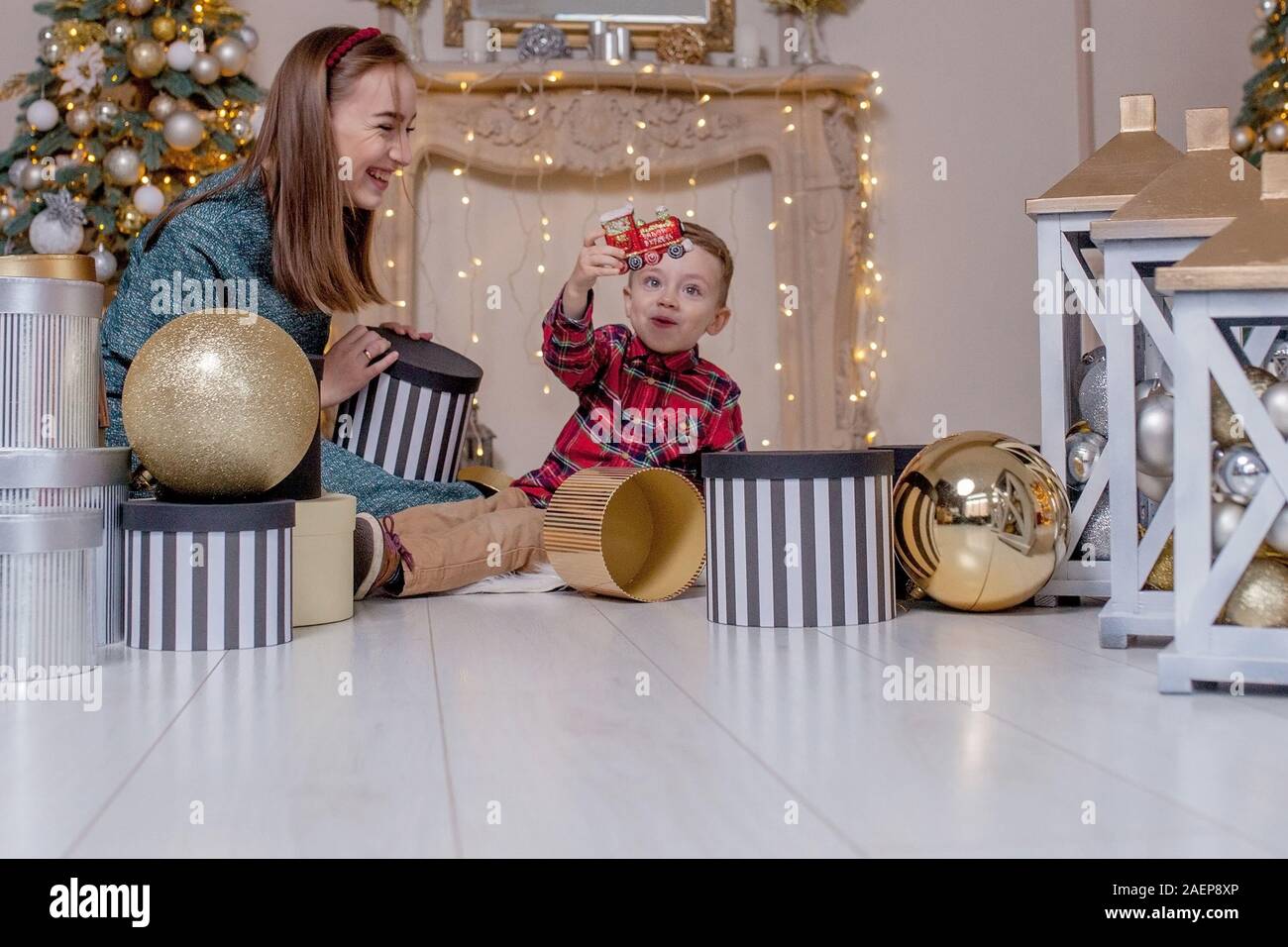 Holidays and presents concept - Close-up of family opening gifts at Christmas time. Stock Photo