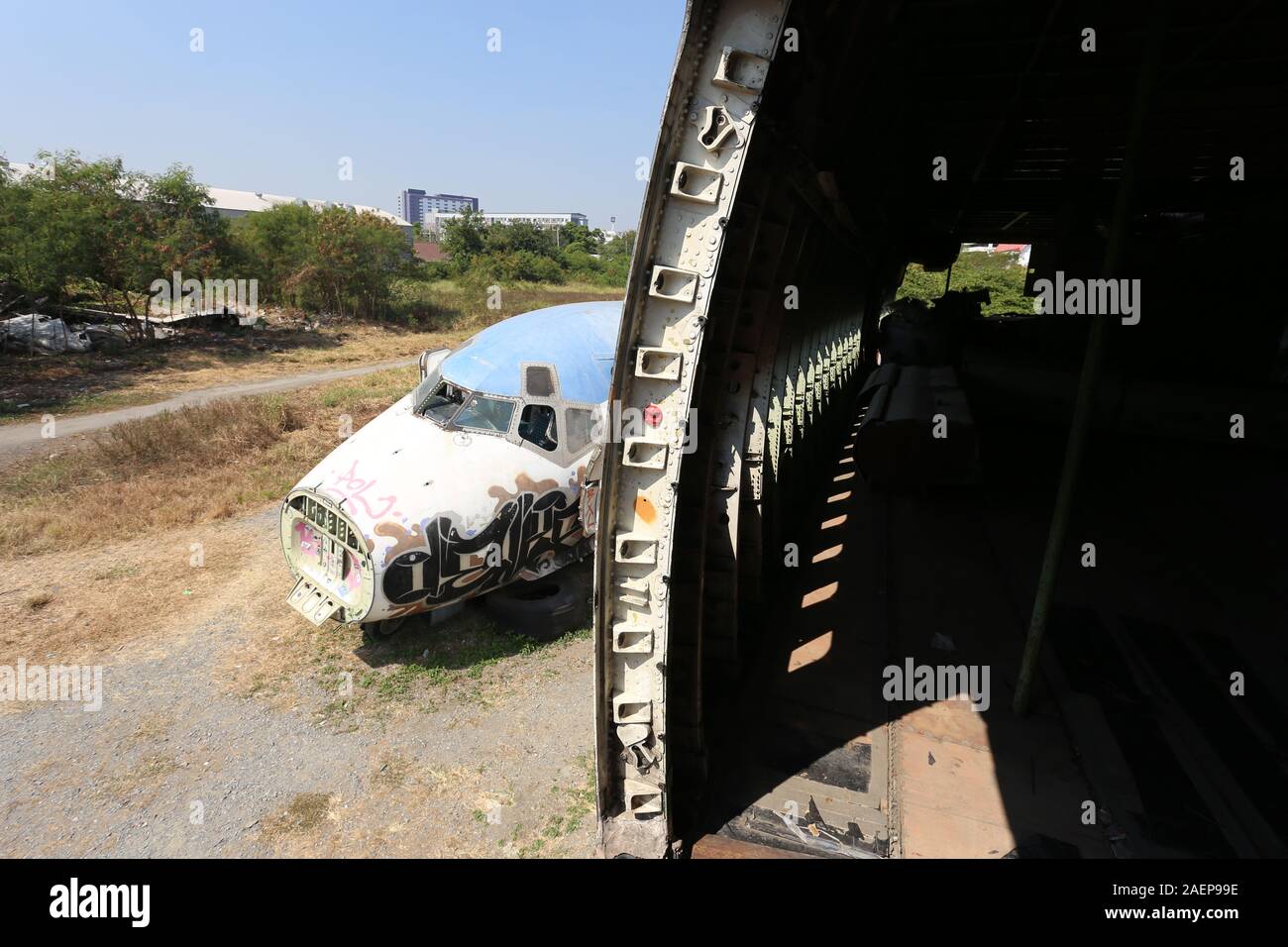 Bangkok's Airplane Graveyard hosts a handful of fuselages and airplane parts that have been partly covered by graffitti Stock Photo