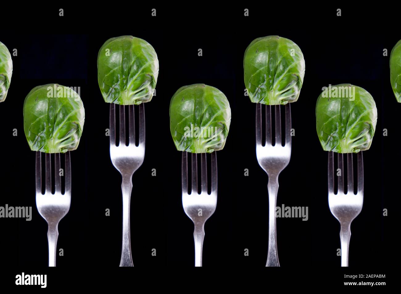 Brussels sprouts on forks.  Eat up and get all your nutrients! Stock Photo