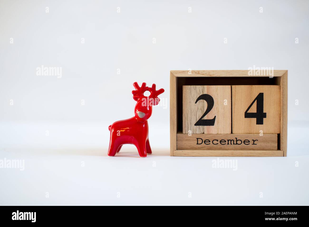 Cube wooden calendar showing date on 24th December with ceramic