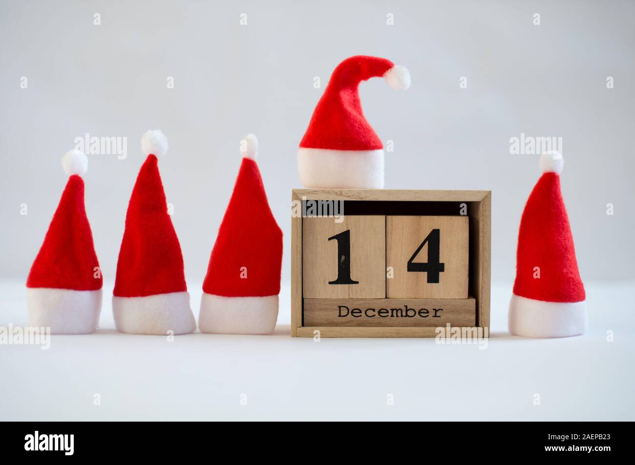 Cube Wooden Calendar Showing Date On 14th December With Small Santa 