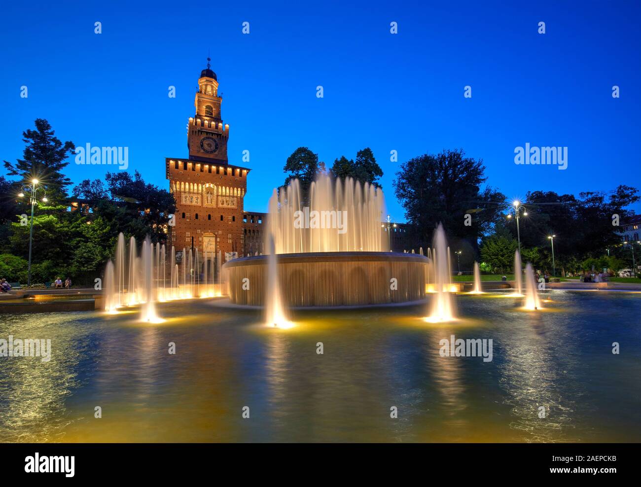 The Sforza Castle with the fountain illuminated at blue hour, Milan, Italy Stock Photo