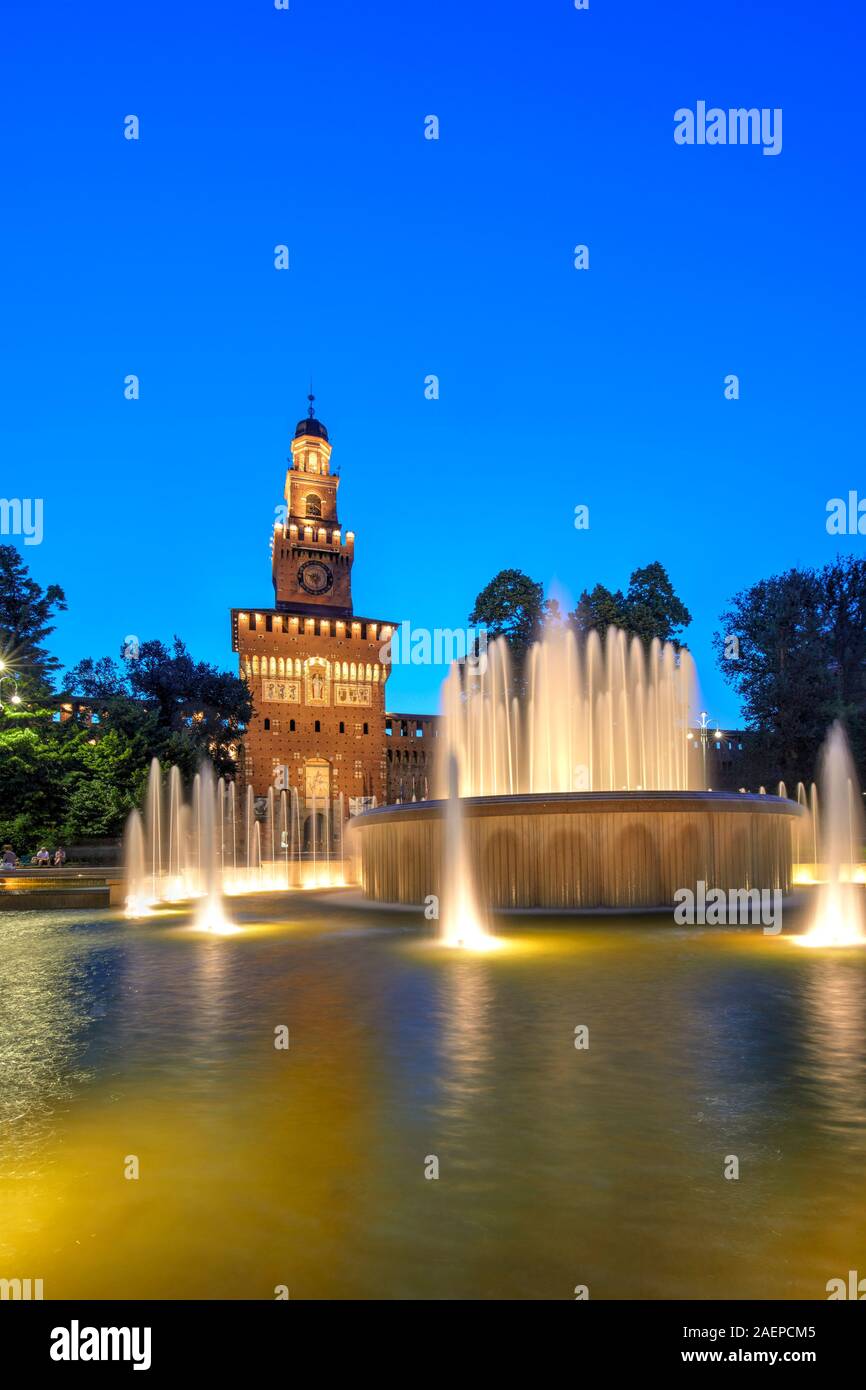 The Sforza Castle with the fountain illuminated at blue hour, Milan, Italy Stock Photo