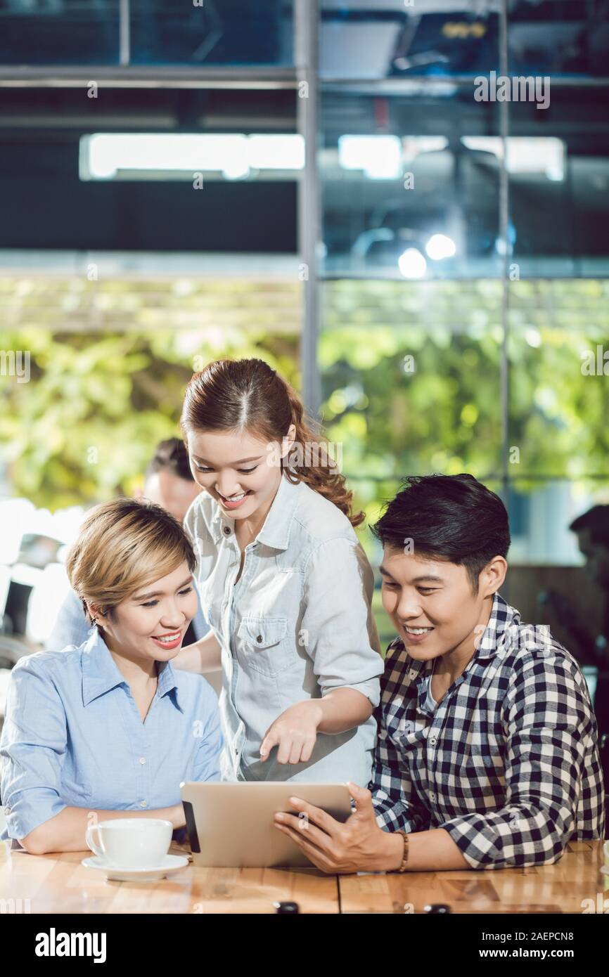 Happy friends looking at digital tablet Stock Photo