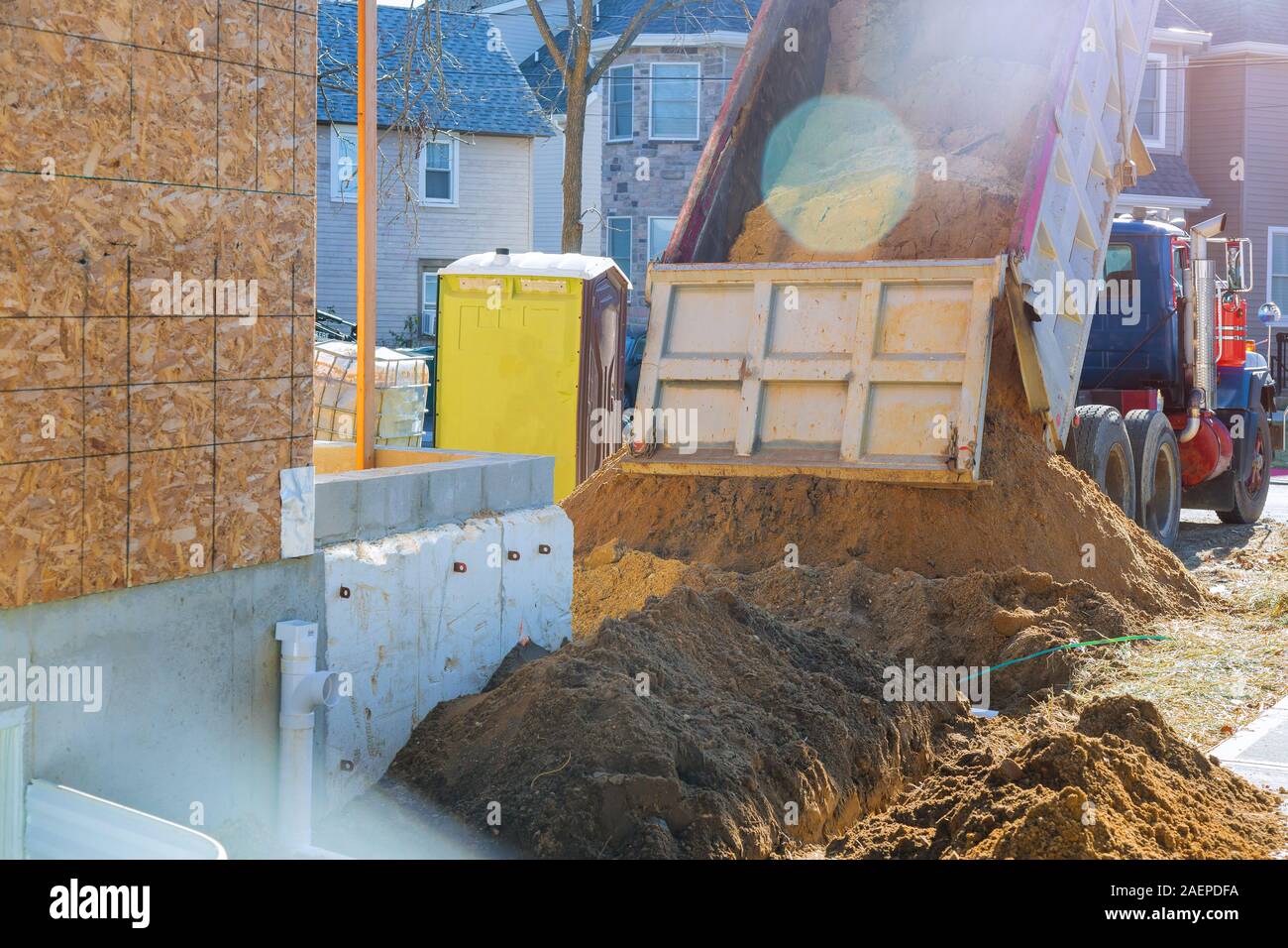 The truck is pouring soil on the ground for construction build a landmark is under construction Stock Photo