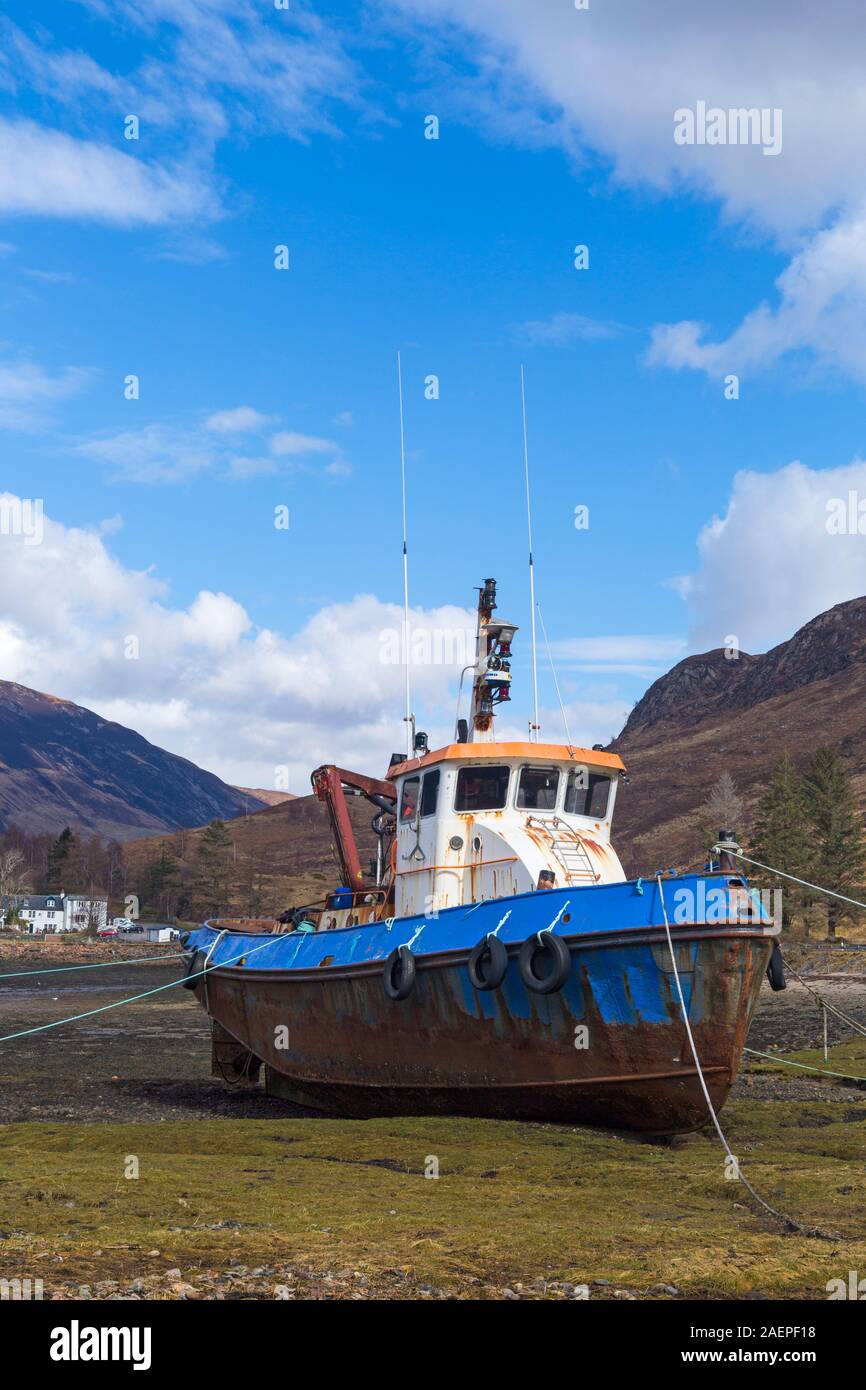 old Fishing boat on shore of Loch Duich, nearby Ratagain Glen Shiel, Isle of Skye, Scotland, UK in March Stock Photo