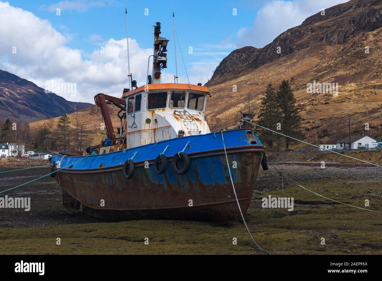 old Fishing boat on shore of Loch Duich, nearby Ratagain Glen Shiel, Isle of Skye, Scotland, UK in March Stock Photo